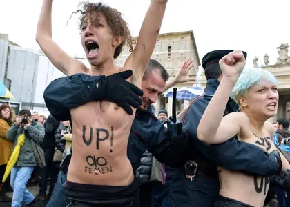 Topless women protest against Berlusconi as he votes In election
