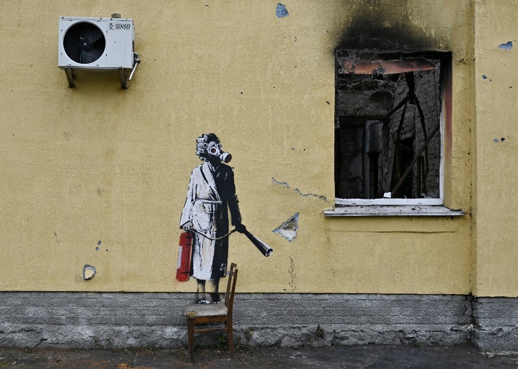 This file photograph taken on November 16, 2022 shows a graffiti made by Banksy on the wall of a destroyed building in the town of Gostomel, near Kyiv, amid the Russian invasion of Ukraine. 