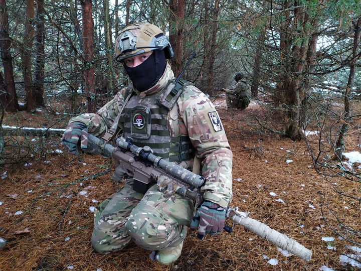 A volunteer from the 100th Separate Brigade of Territorial Defense takes a knee during winter training in Ukraine’s western Volyn region on Nov. 24. In Armed Forces of Ukraine territorial defense units, fighters often equip themselves at personal expense. This infantryman is armed with a non-AFU-issue, semi-automatic rifle firing NATO-standard ammunition, and a high-power aftermarket scope. Photo courtesy the Armed Forces of Ukraine.