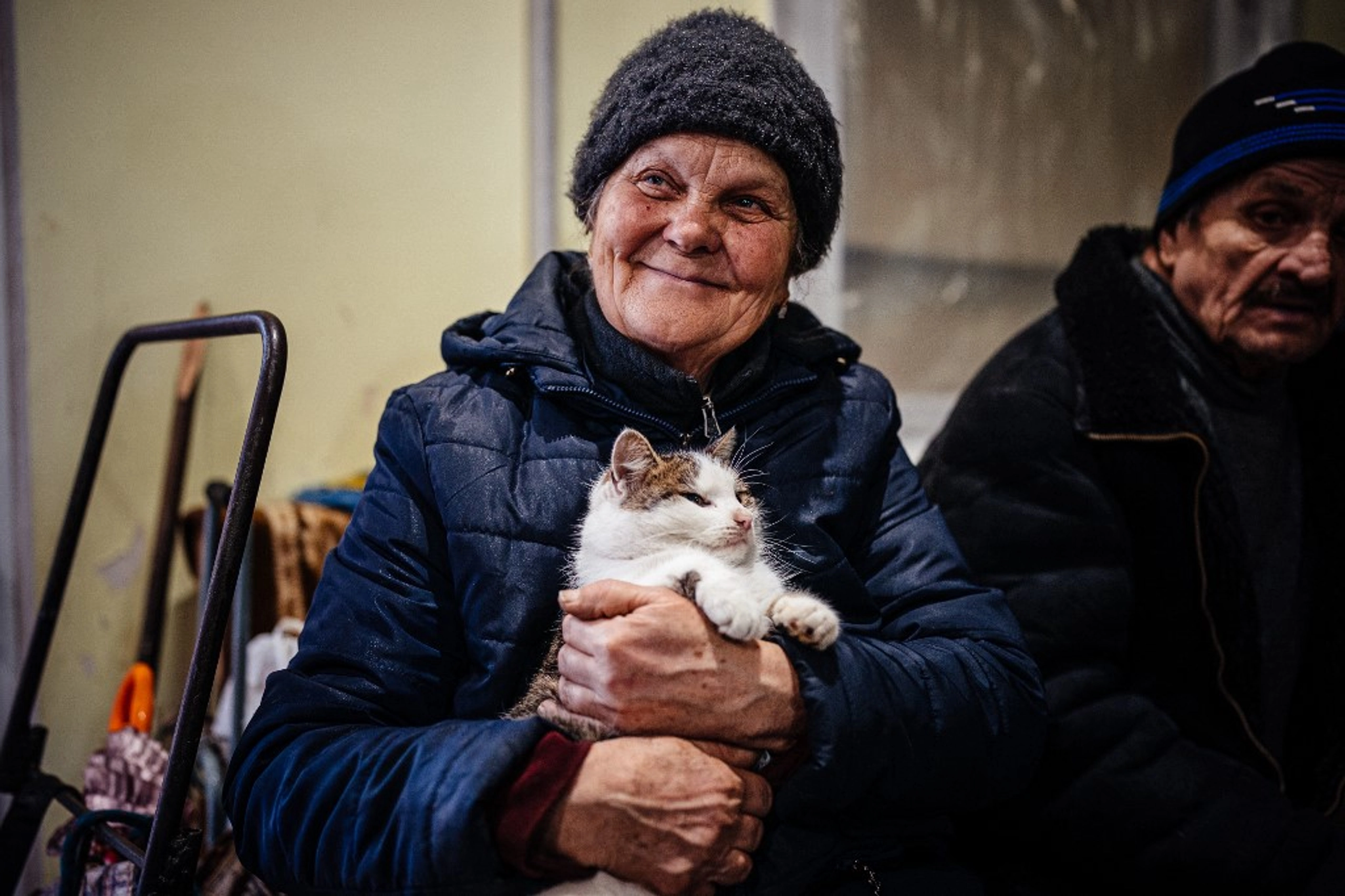 A local resident holds her cat as she sits in a humanitarian aid centre in Bakhmut, Donetsk region, on January 6, 2023. AFP