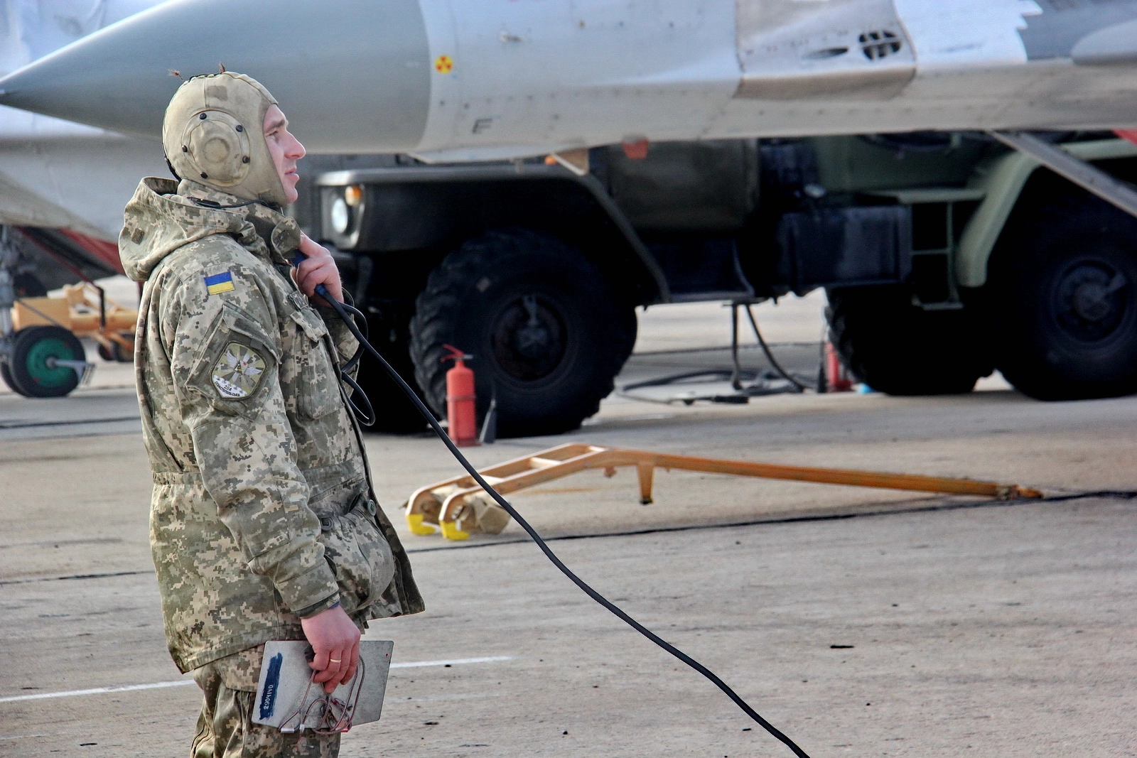 A Ukrainian flight service technician inspects Ukrainian Air Force&#8217;s Mikoyan MiG-29 jets on Feb. 21, 2018.