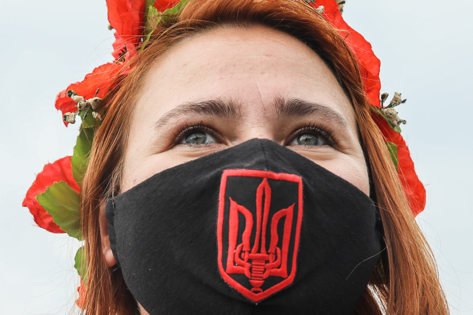 A woman watches the March of Defenders of Ukraine, an event where the participants marched from Shevchenko Park to Maidan Nezalezhnosti as part of Ukraine&#8217;s Independence Day celebrations in Kyiv on Aug. 24, 2020.