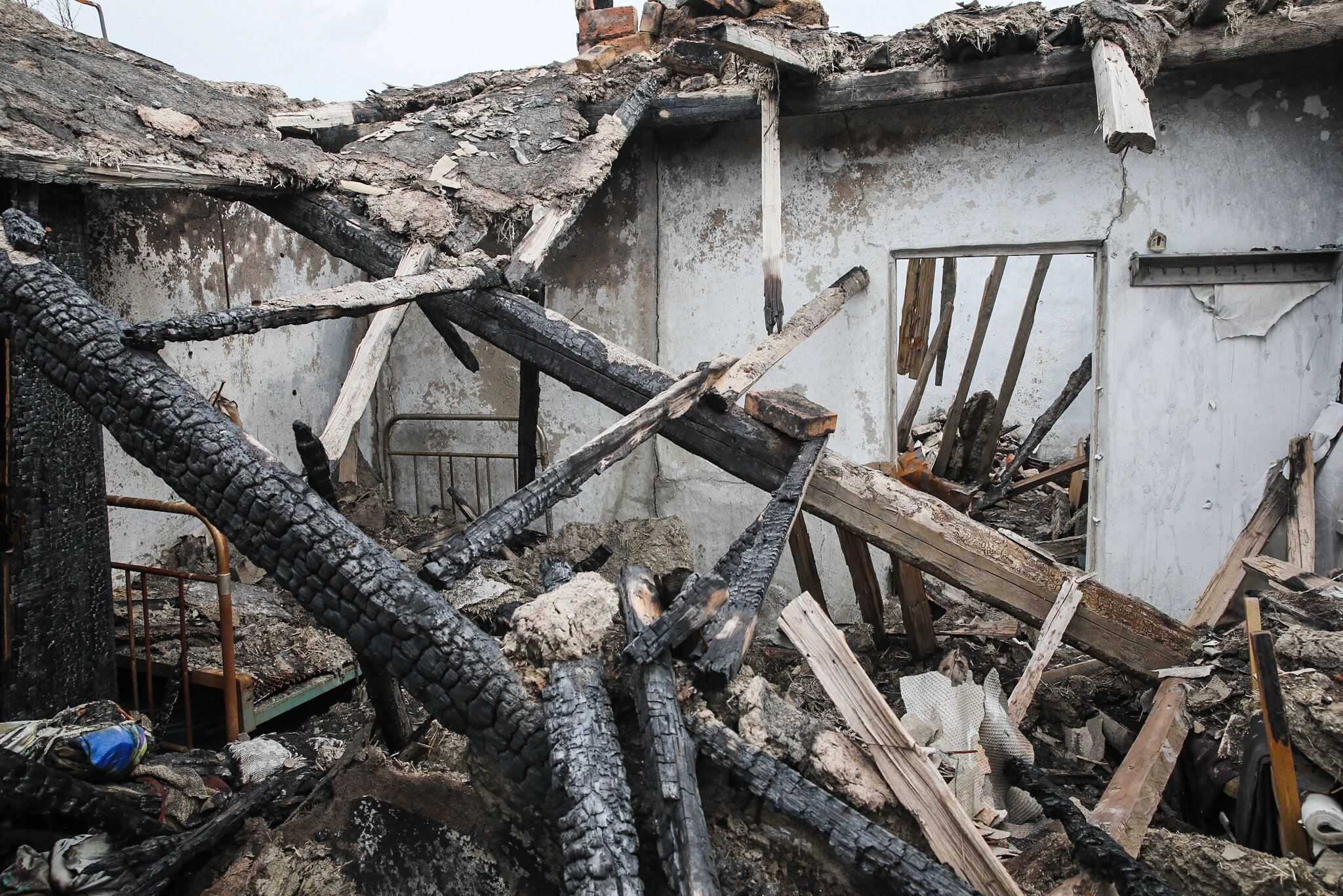 Ruins of a scorched house in the town of Hladosove, pictured on April 27, 2021