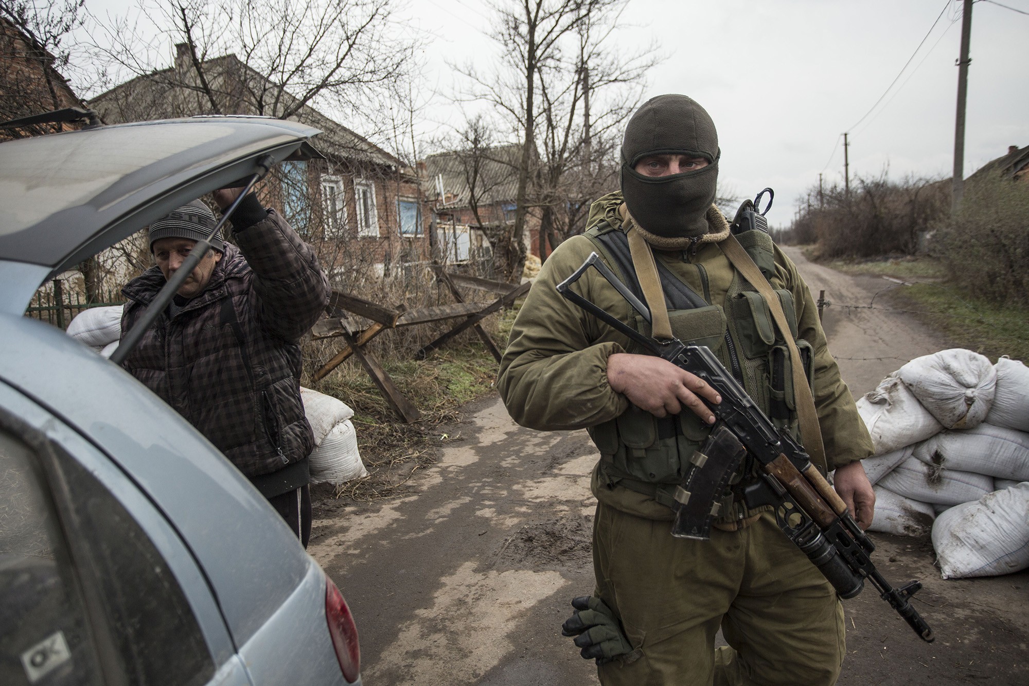 A Ukrainian soldier checks a car in Verkhniotoretske which is heading from the separatist-held zone on Nov. 29.