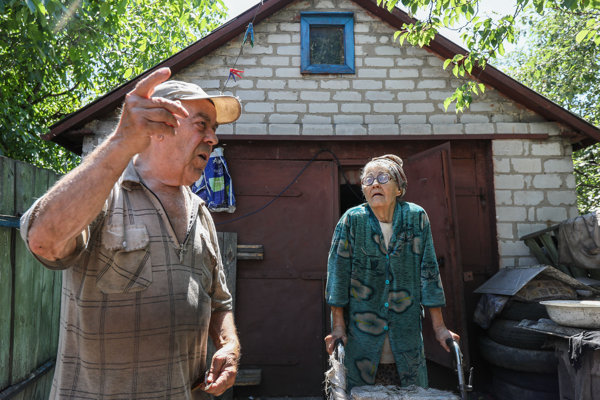 A elderly couple of local civilians talk about the hardships of their everyday life in the frontline town of Zaitseve, eastern Ukraine, on June 25, 2018. 