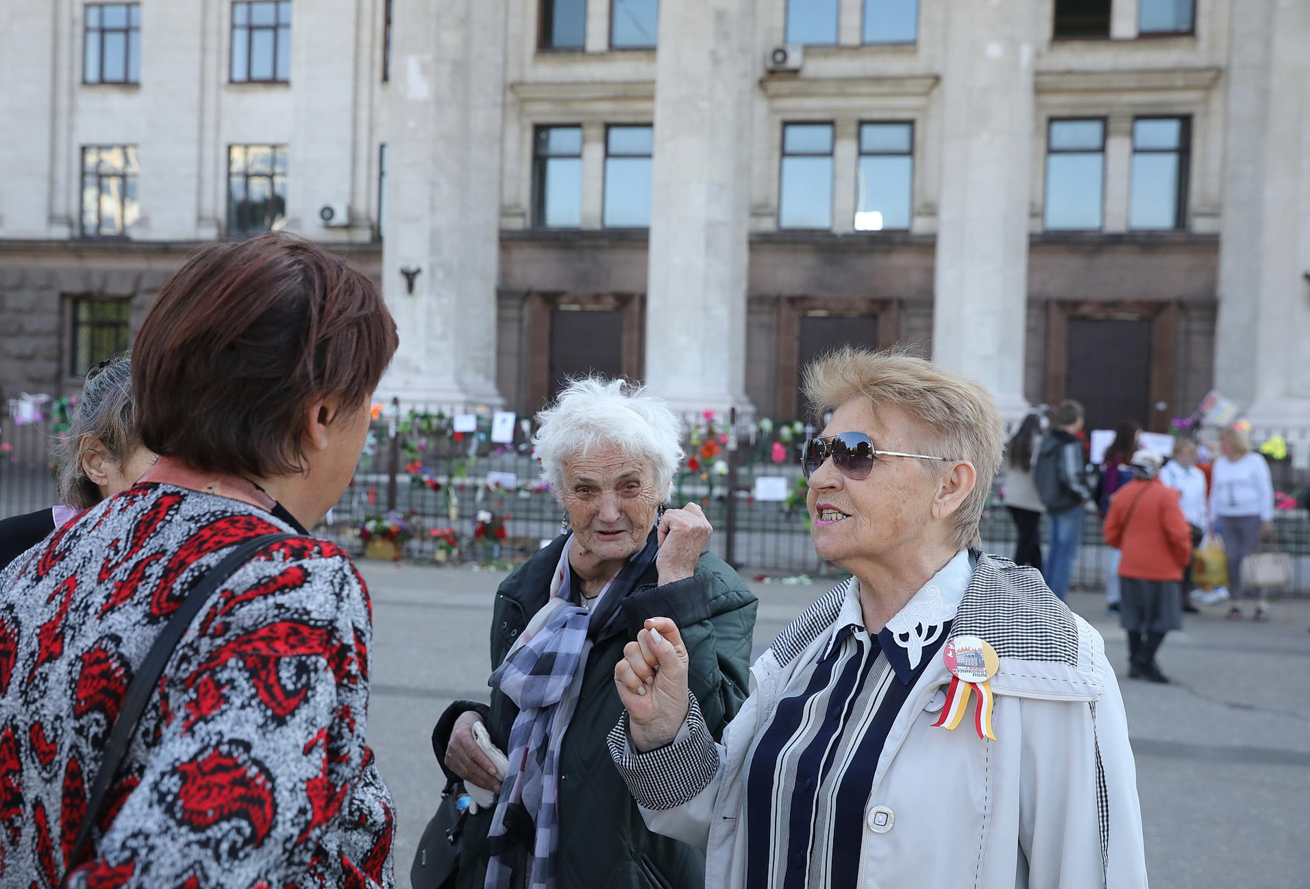 Pro-Russian activists talk near the Trade Unions House in Odesa on May 12, 2019. Many of them are relatives or survivors of the fire that occurred in that building on May 2, 2014.