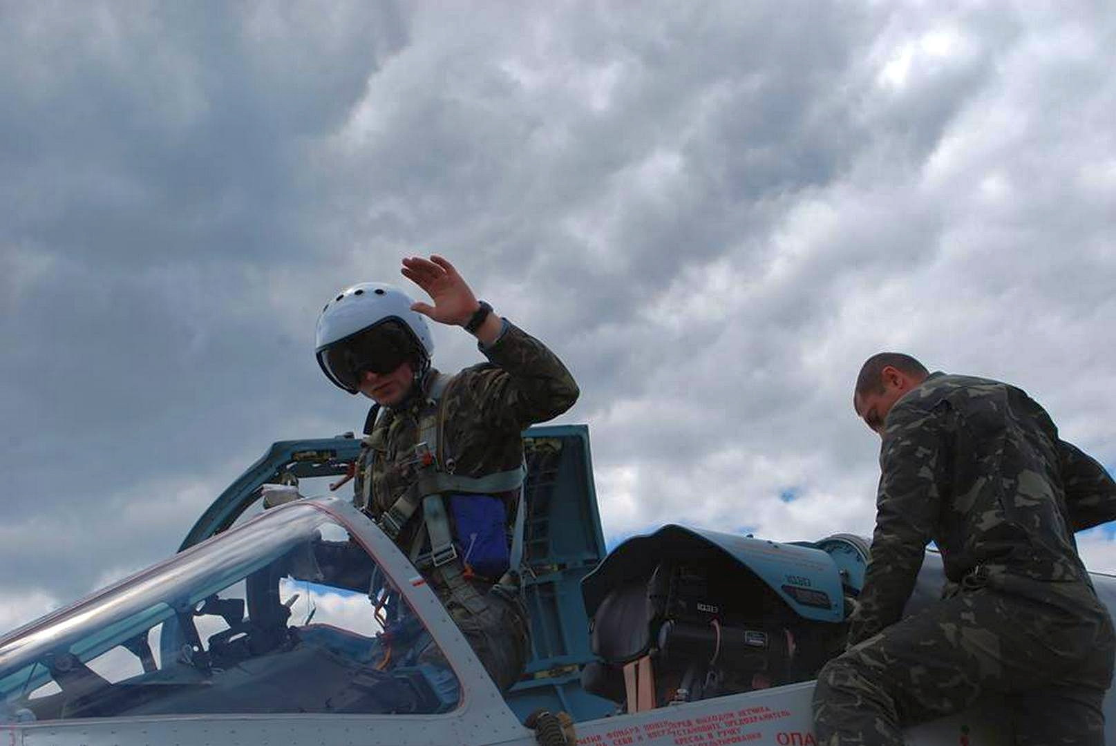 A Ukrainian pilot waves as he prepares for a practice flight during the Clear Sky international drills near the Ivano-Frankivsk airbase on Oct. 14, 2015