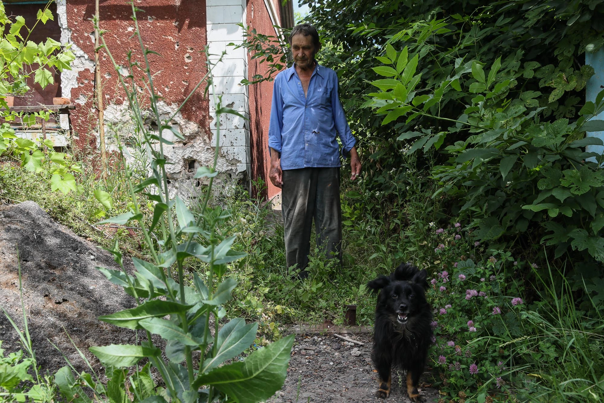 Oleksandr Suprun, a local civilian, walks near his house in the town of Opytne on June 12, 2019.