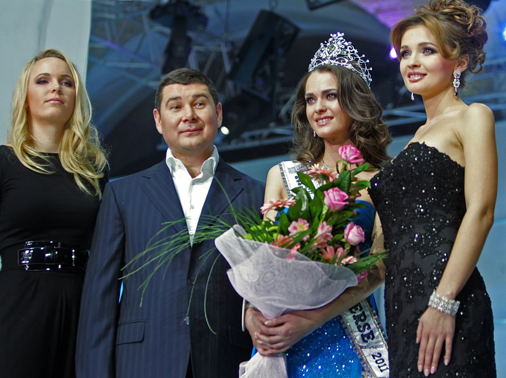 Alexander Onishchenko, a businessman and an owner of a beauty pageants “Miss Ukraine” and “Miss Ukraine Universe”, surrounded by one of the world’s top tennis player Caroline Wozniacki (L), a winner of the Miss Ukraine Universe 2011, Olesya Stefanko (C), and Miss Ukraine Universe 2010 Anna Poslavskaya (R). They are posing for a photograph during the final show of the beauty contest Miss Ukraine Universe 2011 in Kyiv on Dec. 11, 2010.
