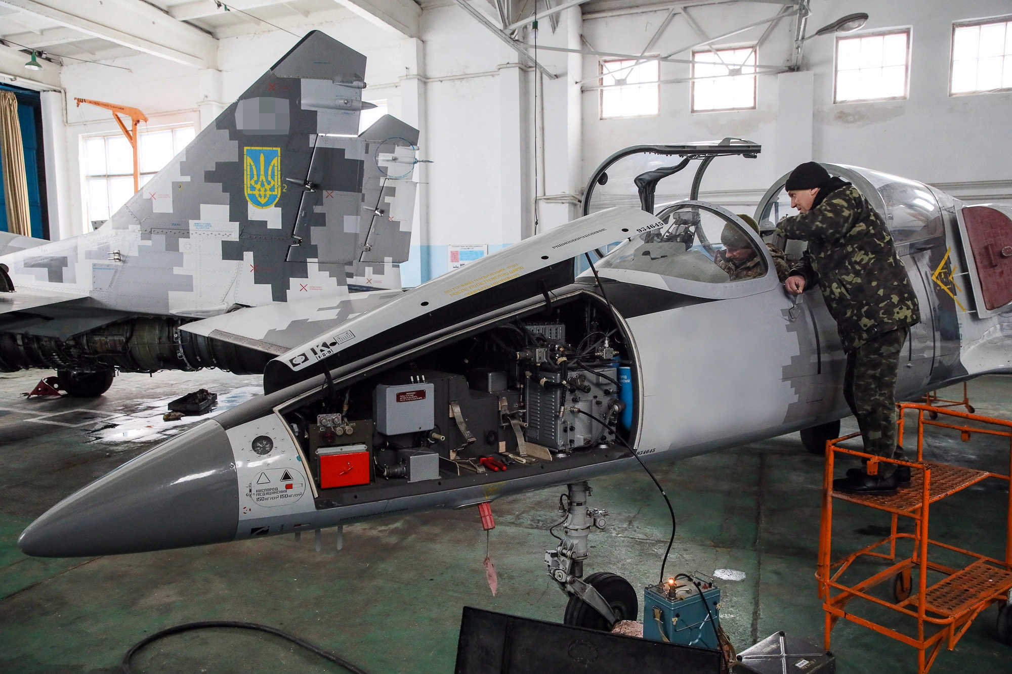 Repair technicians inspect a Ukrainian Air Force&#8217;s L-39 Albatros training plane at an airbase of Vasylkiv on Feb. 14, 2019.