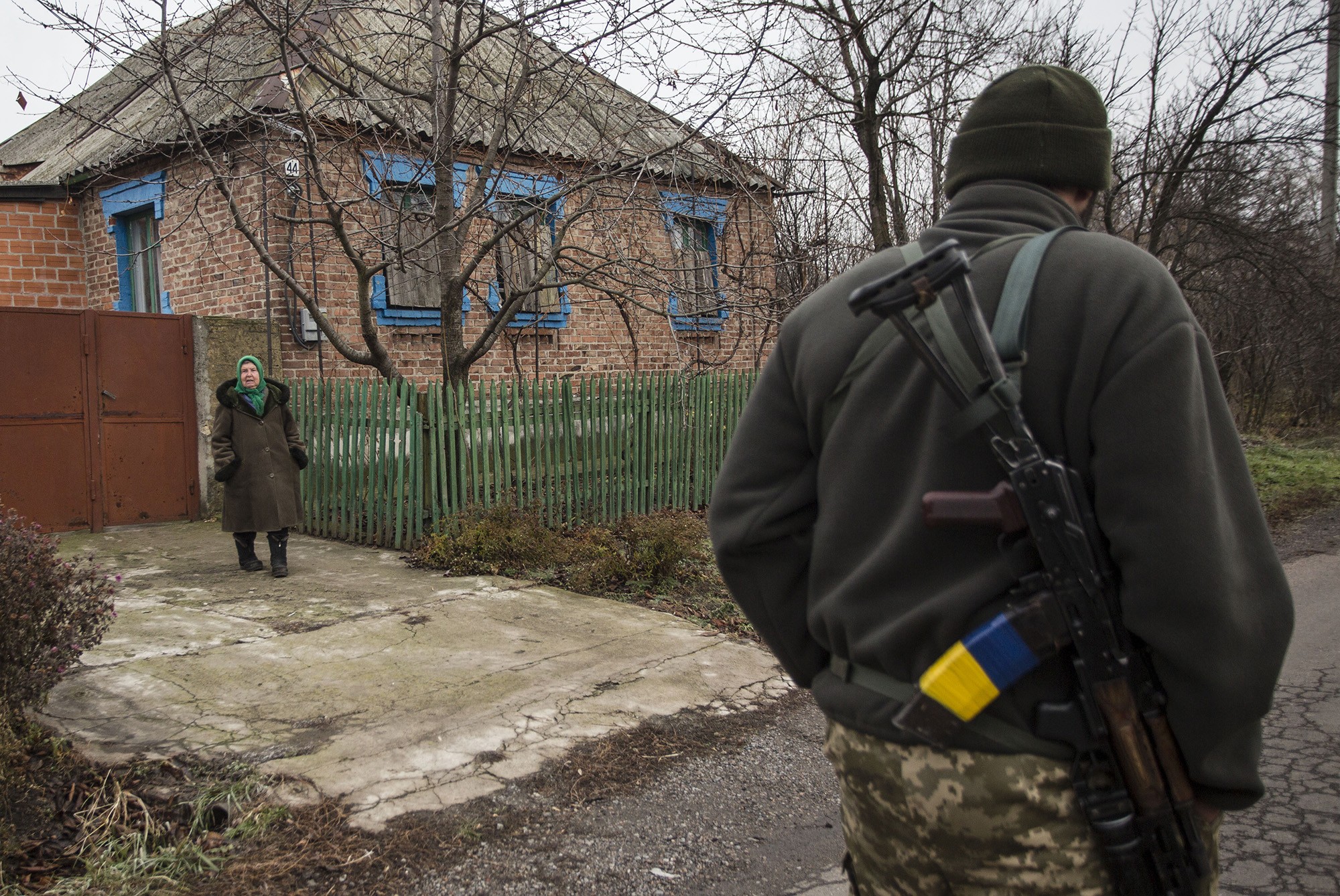 A Ukrainian soldier passes by a local woman in Verkhniotoretske, Donetsk Oblast on Nov. 29.