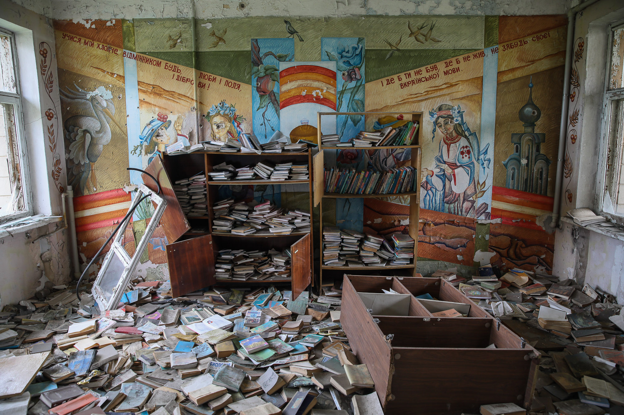 Piles of textbooks scattered on the floor in the ruined local school building in the town of Opytne, eastern Ukraine, pictured on June 12, 2019.