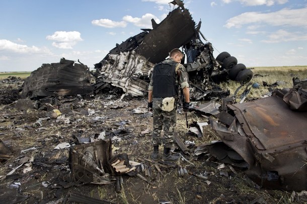 A Russian-backed militant look through the debris of an IL-76 transporter which was taken down by pro-Russian rebels on the outskirts of Lugansk June 14, 2014. 