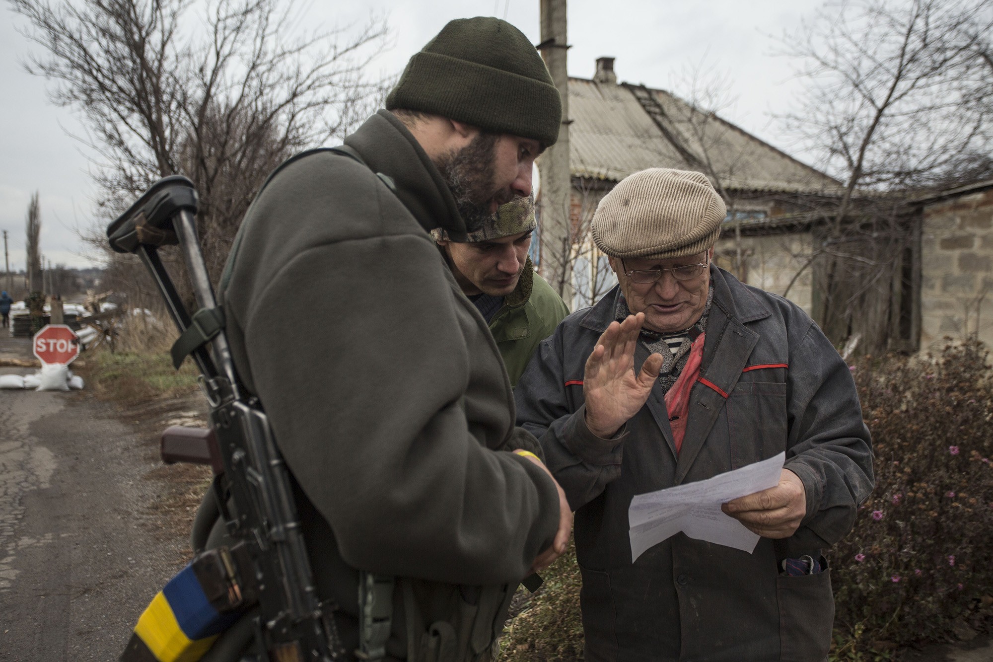 Ukrainian soldiers speak with a local resident on Nov. 29 in Verkhniotoretske, a government-held village in the Donetsk Oblast located a short distance away from territory occupied by Russian-backed militants. A new report from non-governmental organization Center for Civilians in Conflict says Ukraine must do more to address humanitarian challenges in the warzone in order to &#8220;build trust with disenfranchised civilians.&#8221;