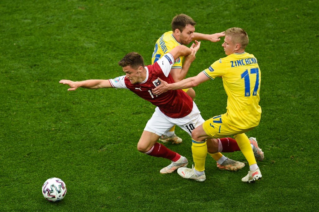 Austria&#8217;s midfielder Christoph Baumgartner (L) fights for the ball with Ukraine&#8217;s defender Oleksandr Karavaev (C) and Ukraine&#8217;s defender Oleksandr Zinchenko (R) during the UEFA EURO 2020 Group C football match between Ukraine and Austria at the National Arena in Bucharest on June 21, 2021. 