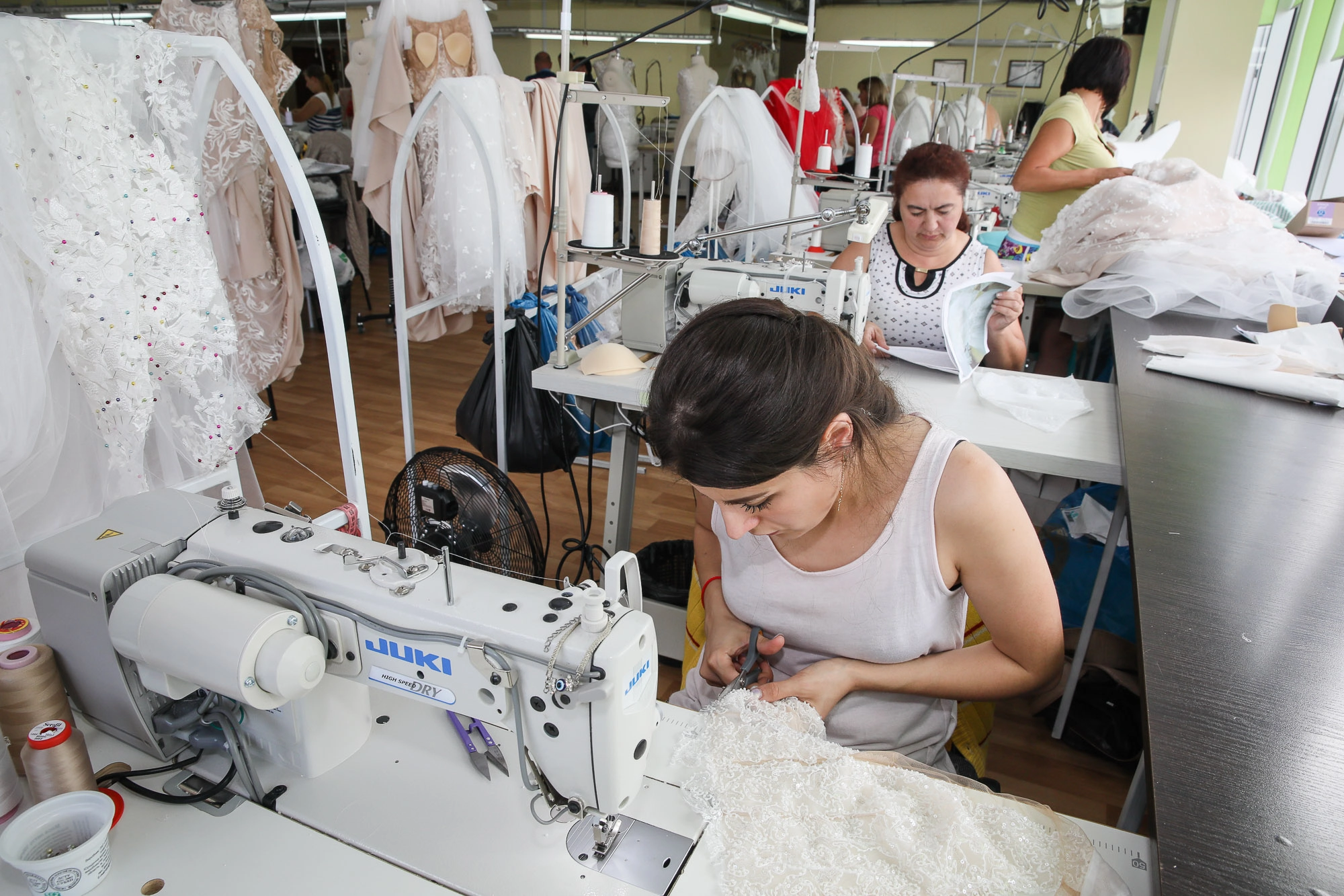 A seamstress works on a new wedding dress. (Volodymyr Petrov)