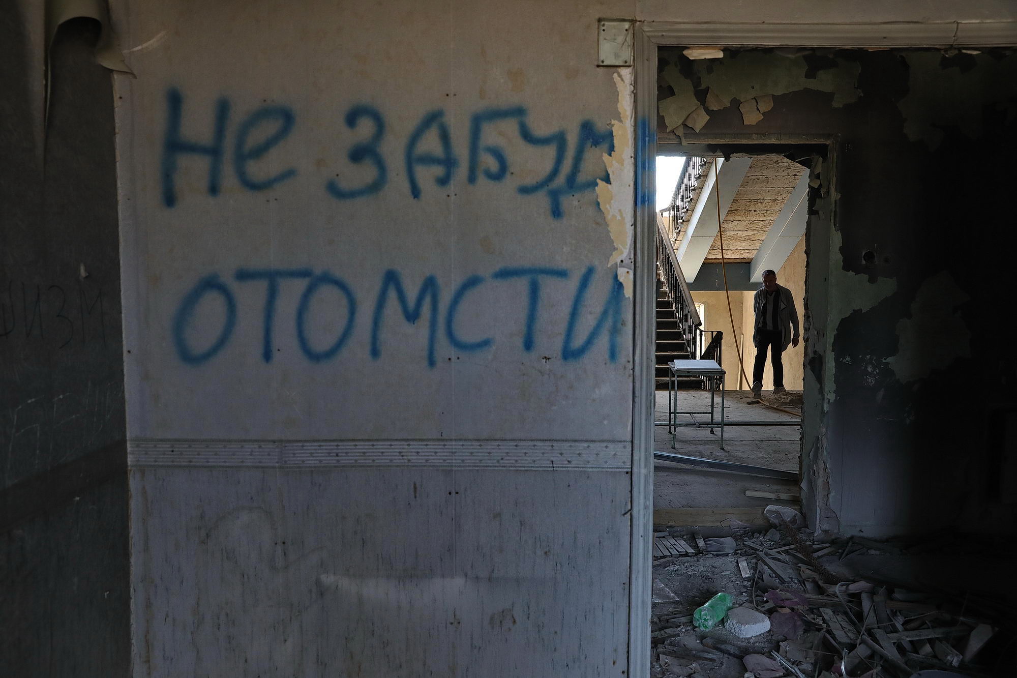 An inscription reading &#8220;We will not forget. (We will) revenge&#8221; is seen on a wall in the Trade Unions House in Odesa on May 13, 2019. An employee of the building is seen from distance. The 42 pro-Russian activists were killed by the fire there on May 2, 2014. Law enforcement failed to give any clear answers about those events. 