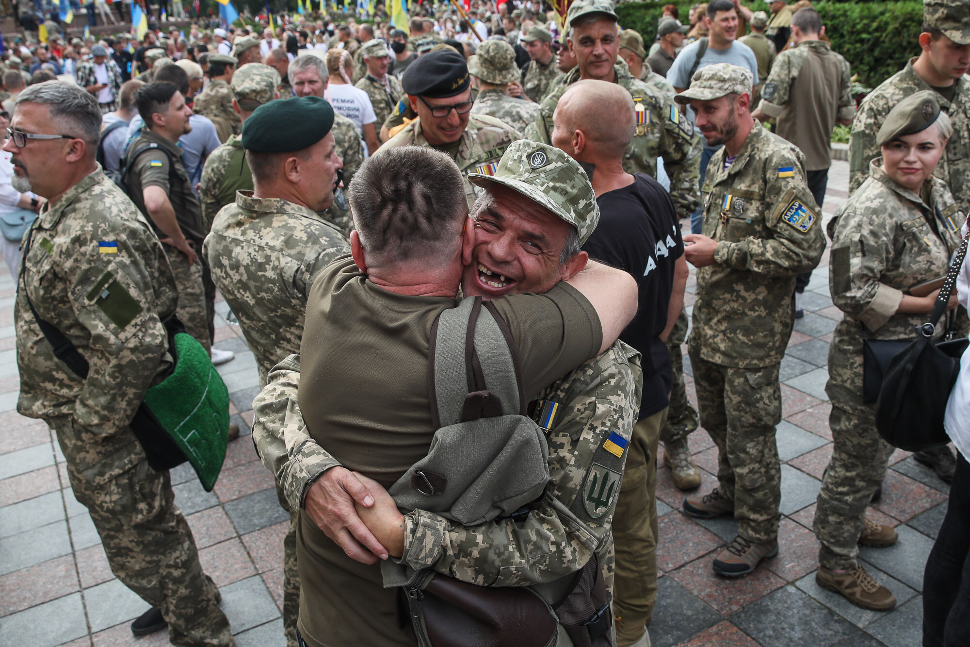Soldiers hug as they meet before the March of Defenders of Ukraine, an event where the participants marched from Shevchenko Park to Maidan Nezalezhnosti as part of Ukraine&#8217;s Independence Day celebrations in Kyiv on Aug. 24, 2020.