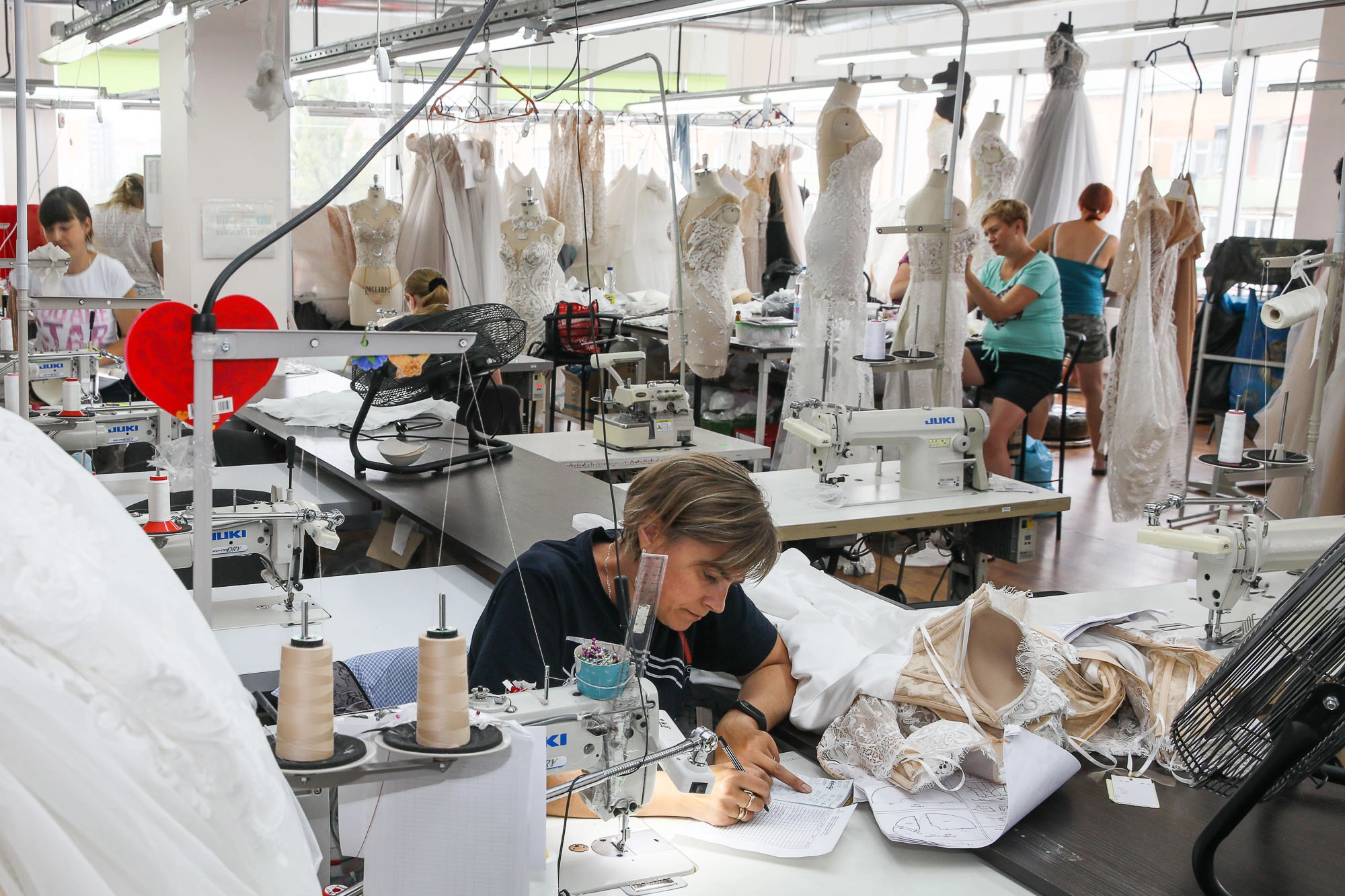 A seamstress works on a new wedding dress. (Volodymyr Petrov)