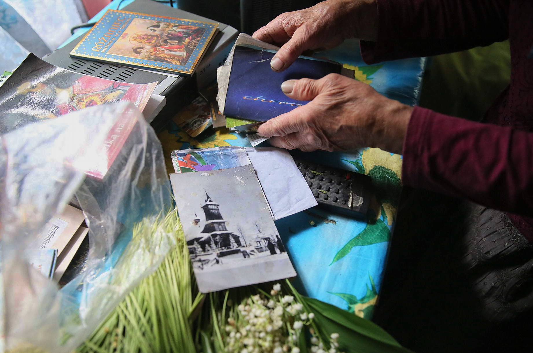 Oleksandra Vaseiko shows postcards and photos in her house in the village of Sokil in Volyn Oblast.