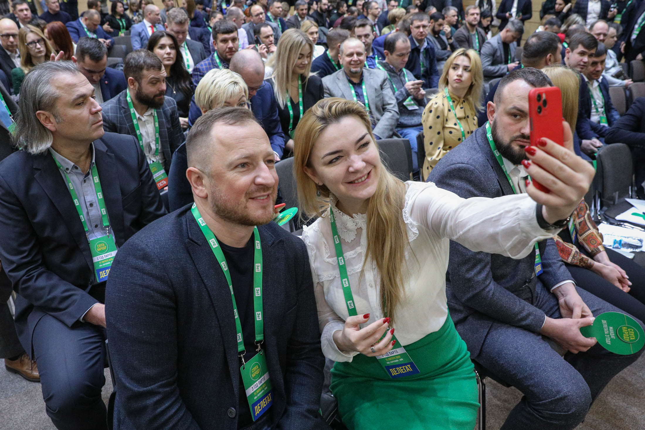 Party members take a selfie as they wait for the start of the Servant of the People party congress at the Parkovy convention center on Feb. 15, 2020.