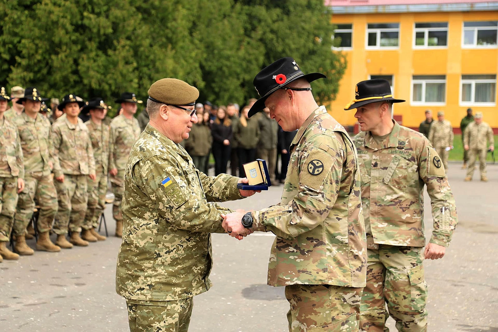 Ukraine’s Armed Forces Lieutenant General Pavlo Tkachuk decorates U.S. Army personnel during the transfer of authority ceremony of the JMTG-U training mission at the Yavoriv training range on May 2, 2019.