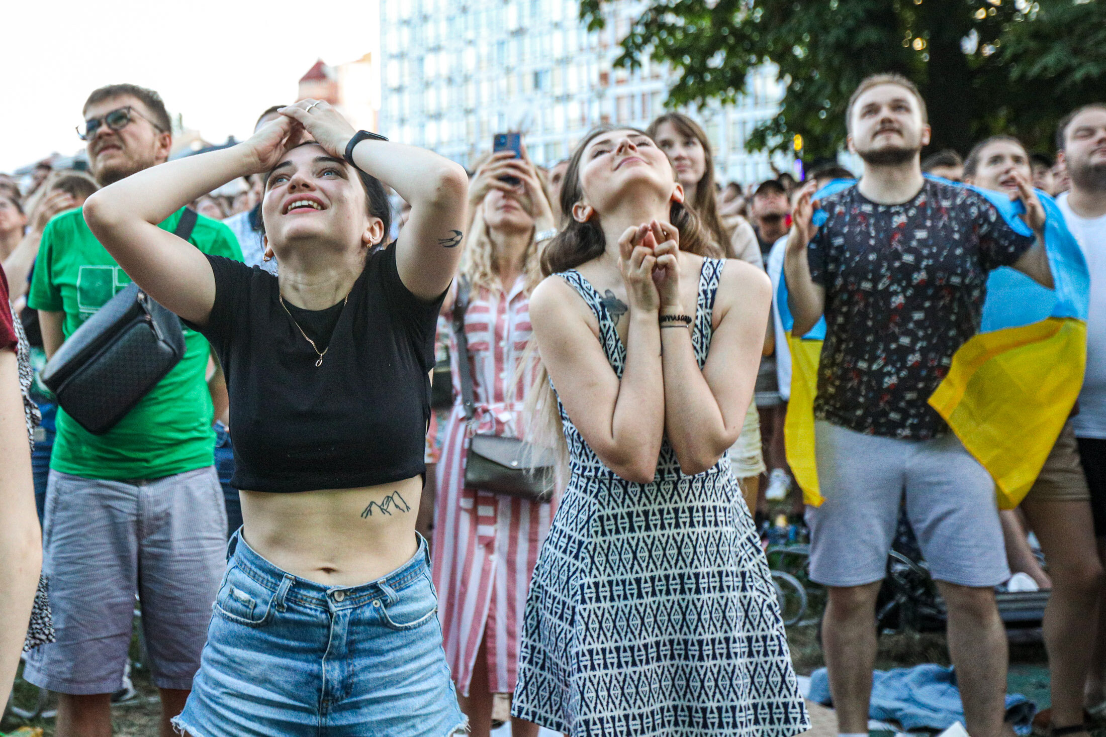 Ukrainian supporters reacts as they watch the  UEFA EURO 2020 Group C football match between Ukraine and Austria on a giant screen in the center of Kyiv on June 21, 2021.