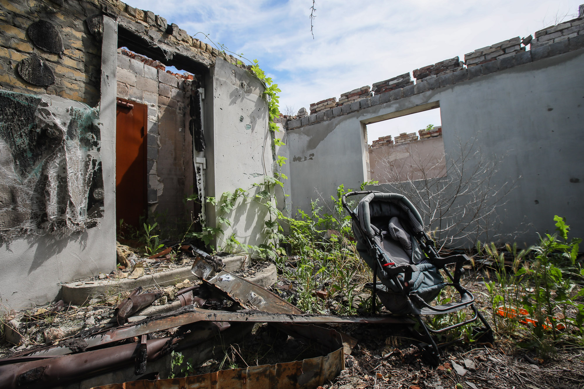 A baby trolley abandoned near a ruined house, pictured in the town of Opytne, eastern Ukraine, on June 12, 2019.