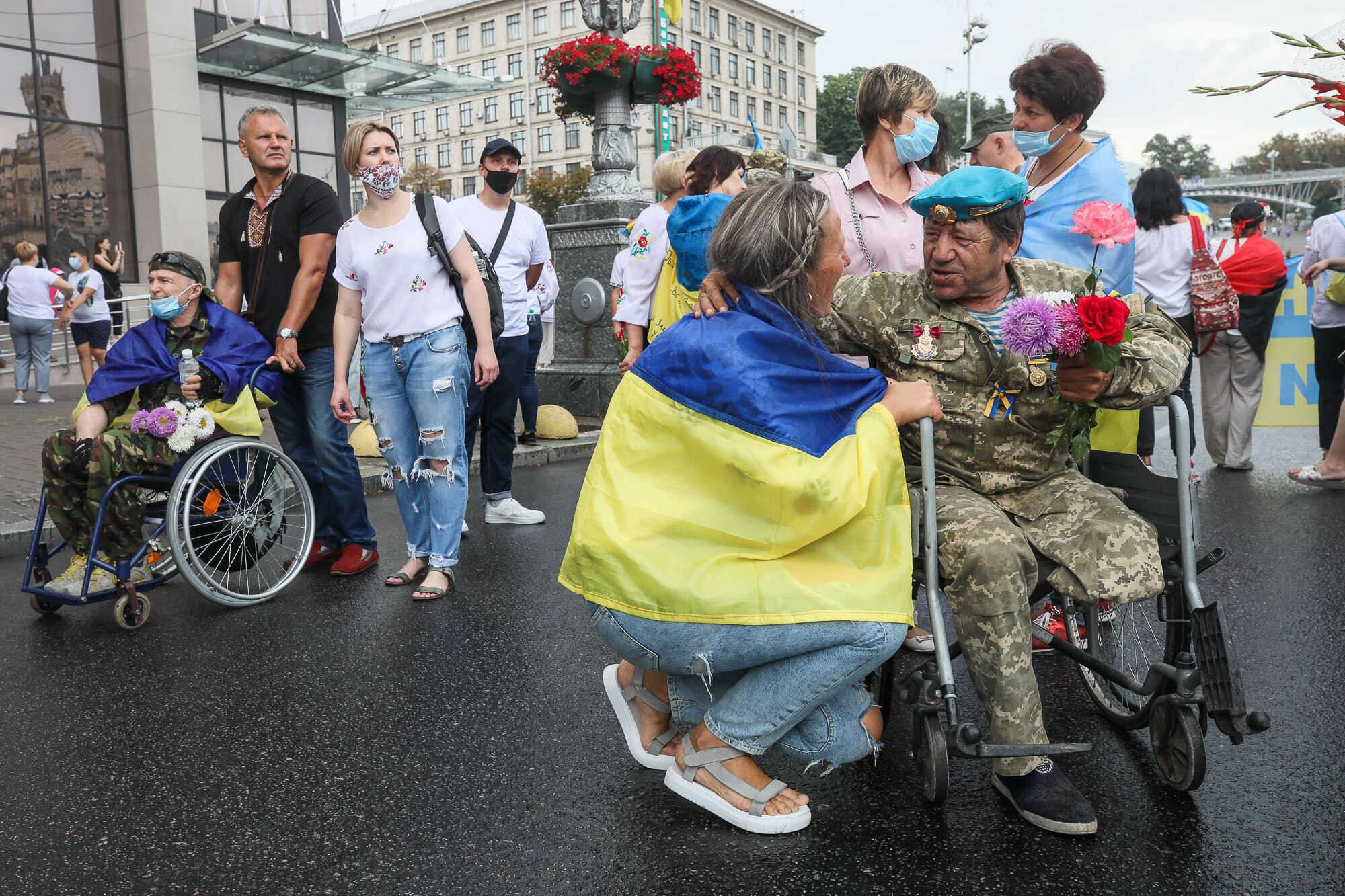 A woman talks with a soldier as Ukrainian veterans and activists participate in the March of Defenders of Ukraine, an event that celebrated Ukraine&#8217;s Independence Day in Kyiv on Aug. 24, 2020.