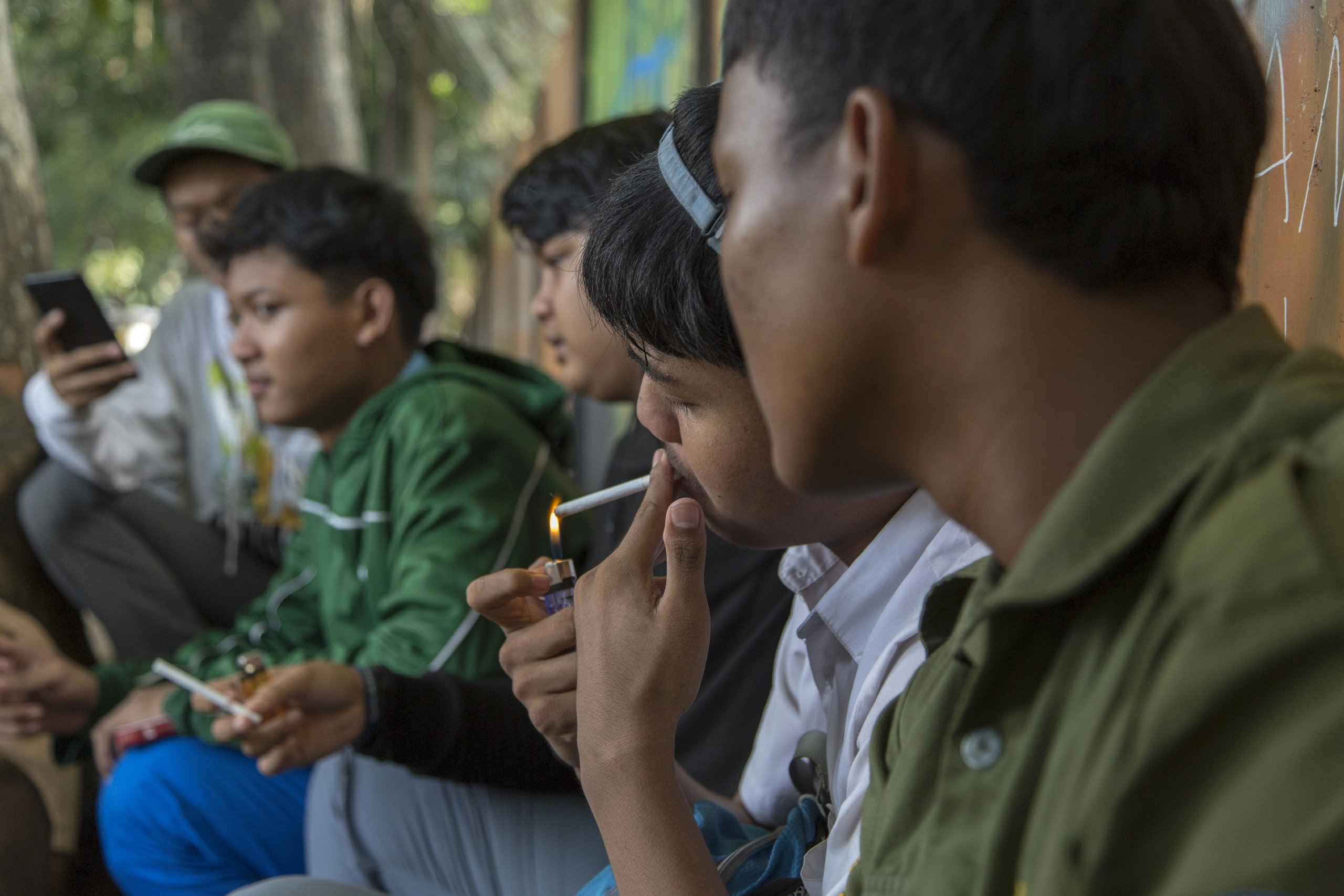 Students hang out after school while smoking cigarretes in Bogor, West Java.