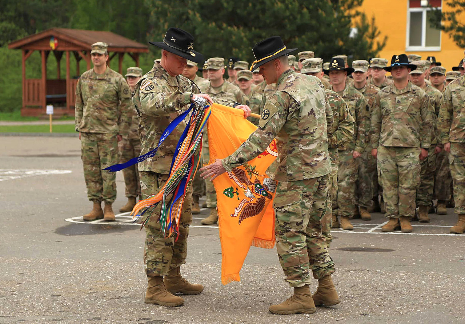 U.S. Army personnel case their unit colors during the transfer of authority ceremony of the JMTG-U training mission at the Yavoriv training range on May 2, 2019.