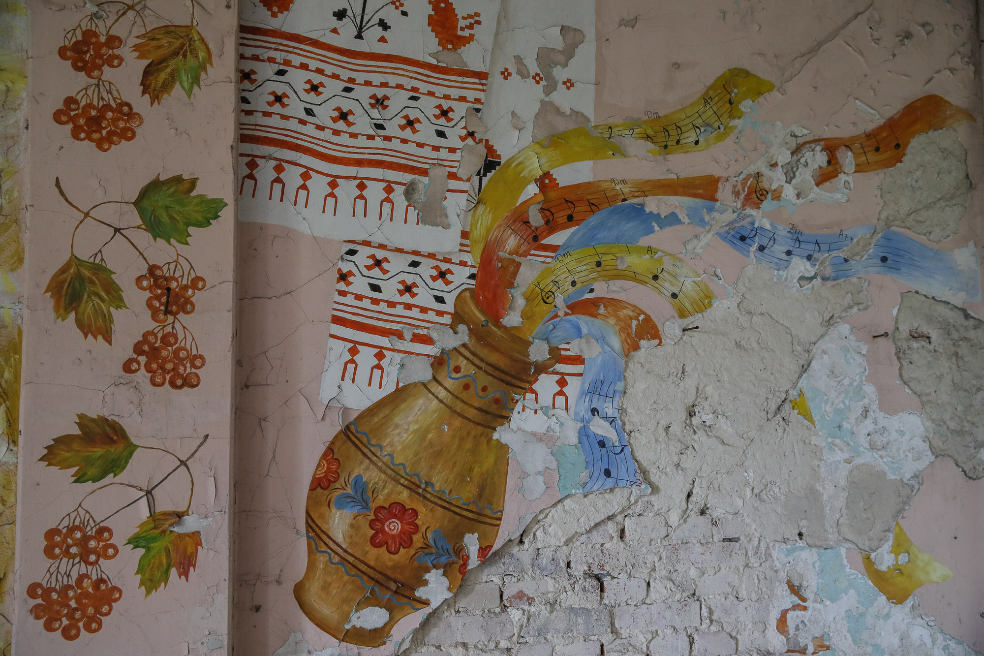 A damaged painting on a ruined school library wall pictured in the town of Opytne, pictured on June 12, 2019.