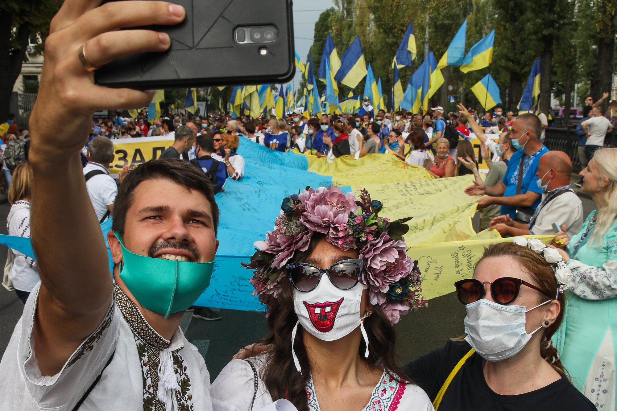 People take a selfie as Ukrainian veterans and activists participate in the March of Defenders of Ukraine as part of Ukraine&#8217;s Independence Day celebrations in Kyiv on Aug. 24, 2020.