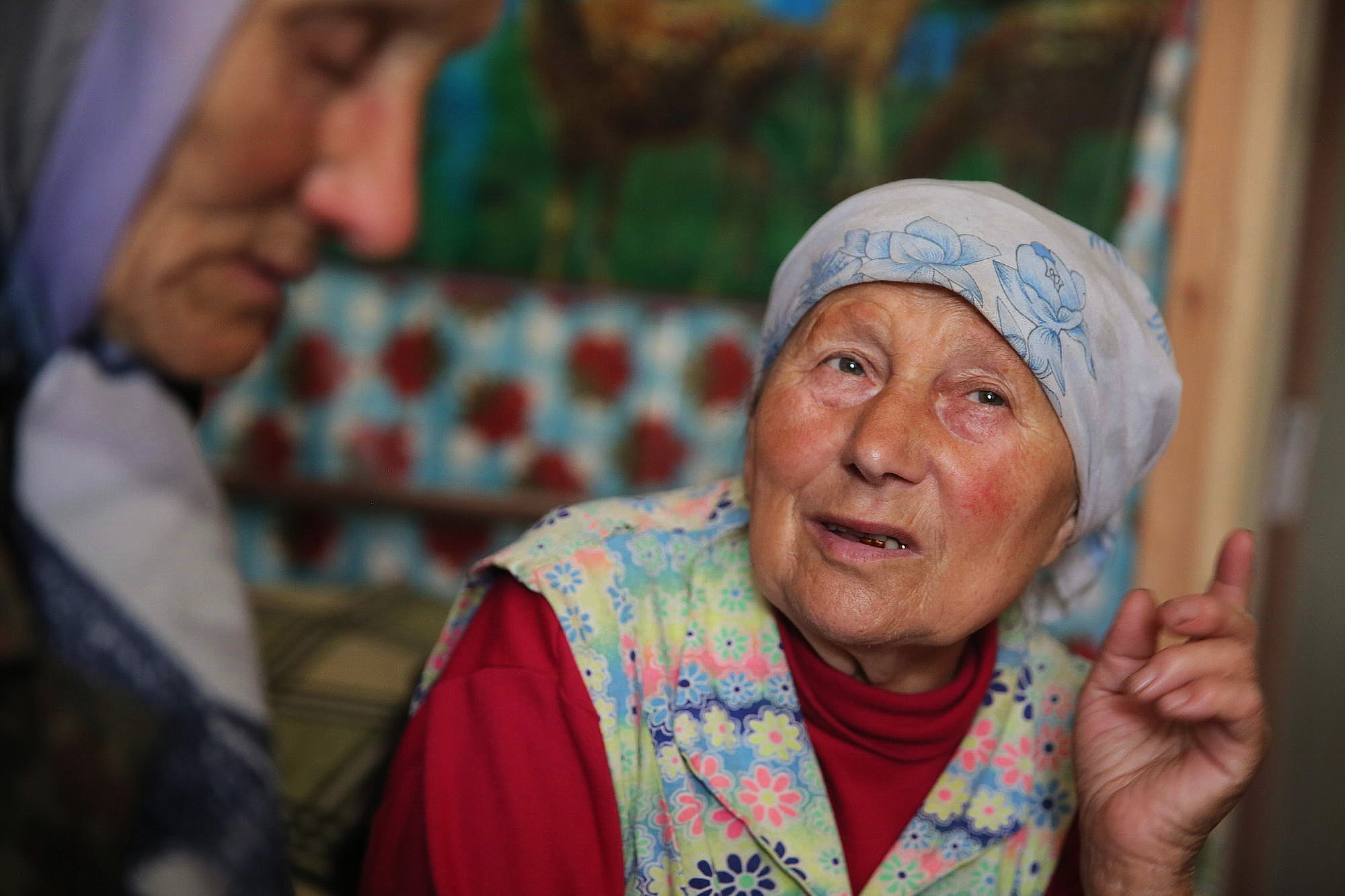Oleksandra Vaseiko (L) listens to her friend Olga Silchuk in Silchuk&#8217;s house in the village of Sokil of Volyn Oblast.
