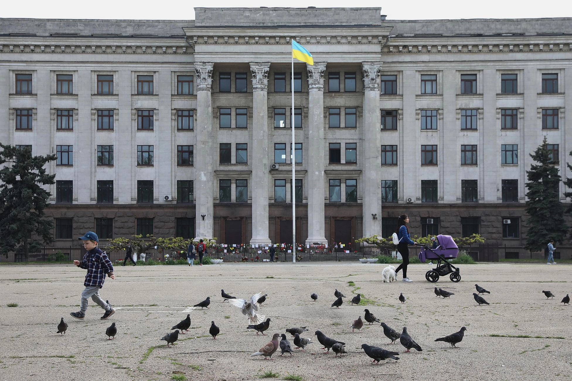 Pedestrians walk next to the Trade Unions House on May 13, 2019, in Odesa. The 42 people were killed by the fire there on May 2, 2014. They were either burned down, suffocated from smoke or jumped out of the windows escaping the blaze. 