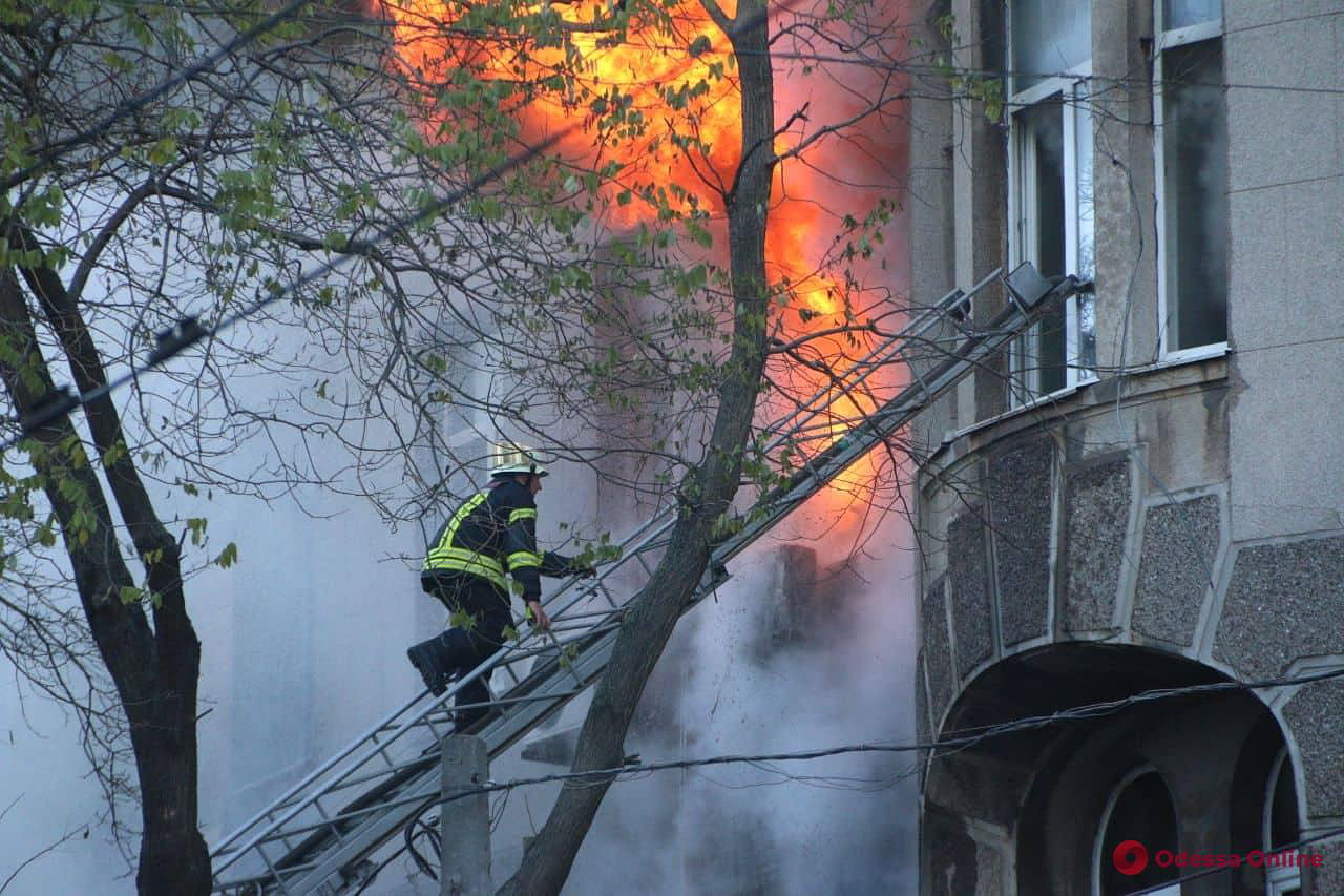 A firefighter climbs to the window to extinguish a fire in central Odesa on Dec. 4, 2019.