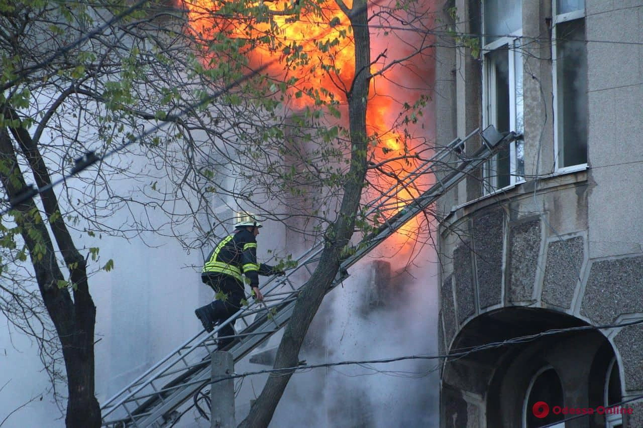 A firefighter climbs to the window to extinguish a fire in central Odesa on Dec. 4, 2019.