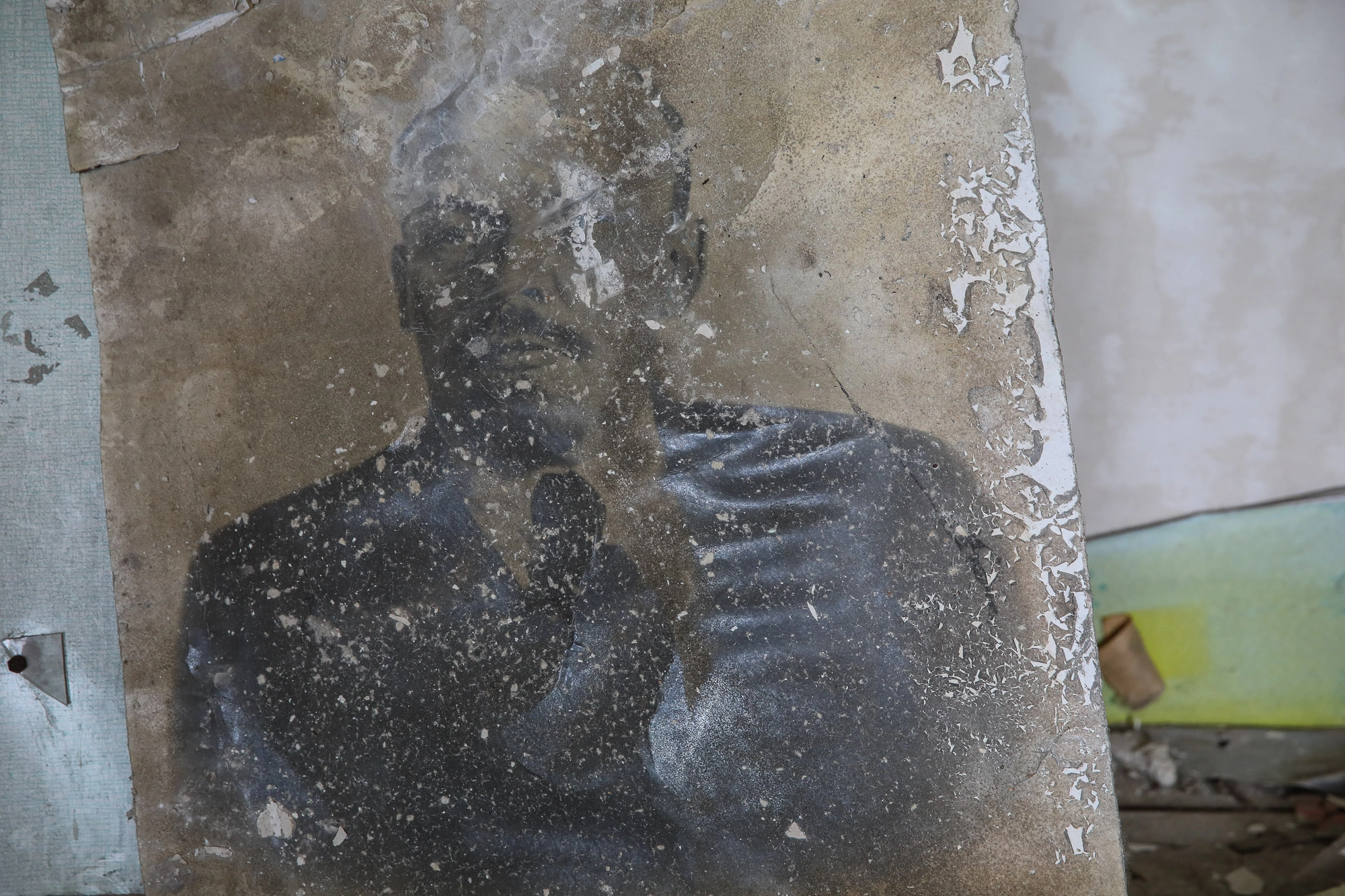 A withered portray of Vladimir Lenin, pictured in a ruined school library building in the town of Opytne, pictured on June 12, 2019.