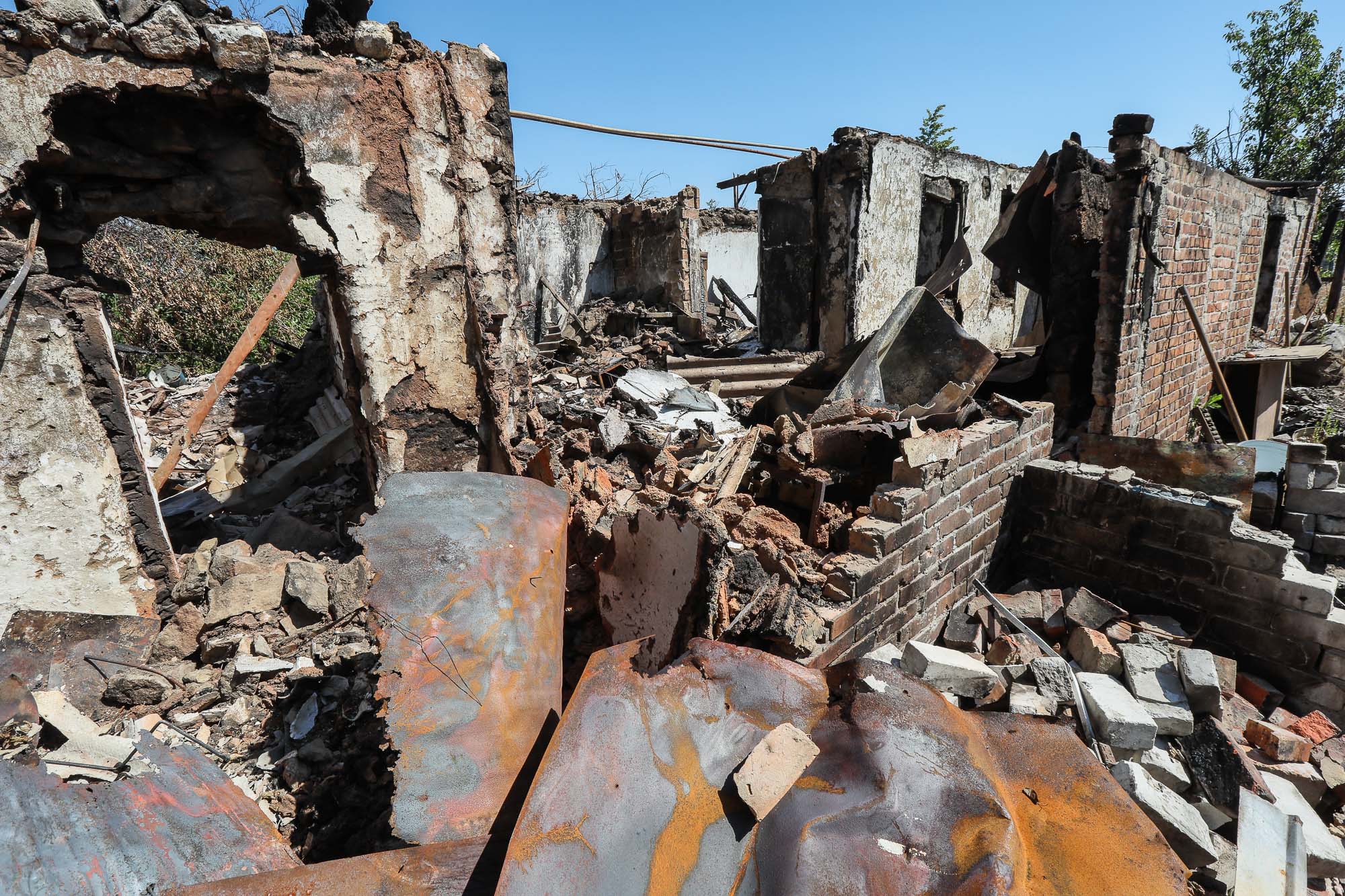 Ruins of shelled civilian houses are seen in the town of Zaitseve on June 25, 2018. 