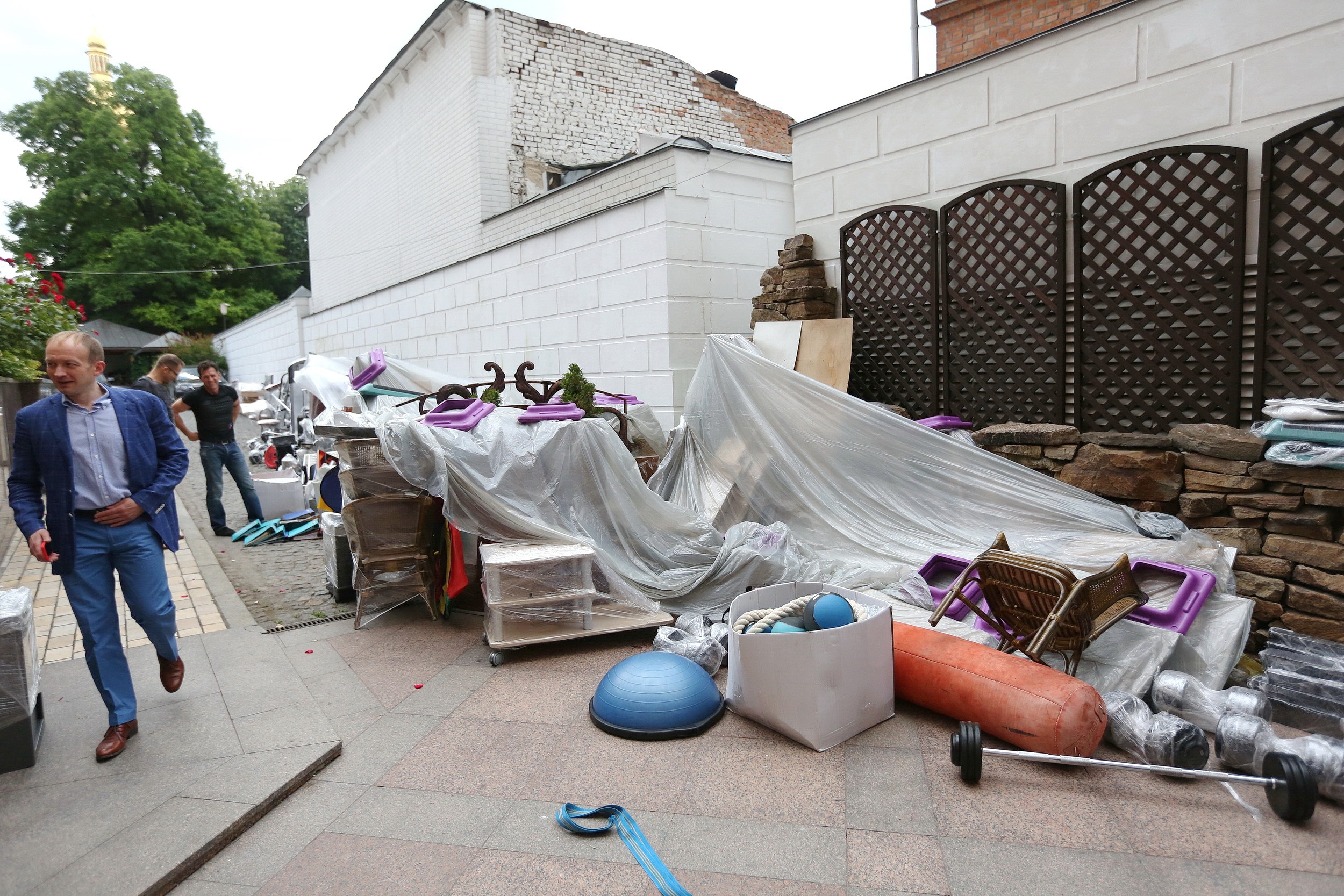 Furniture and gym equipment lies dumped on the back terrace of the Sofiyskiy Fitness Center in Kyiv on June 13.