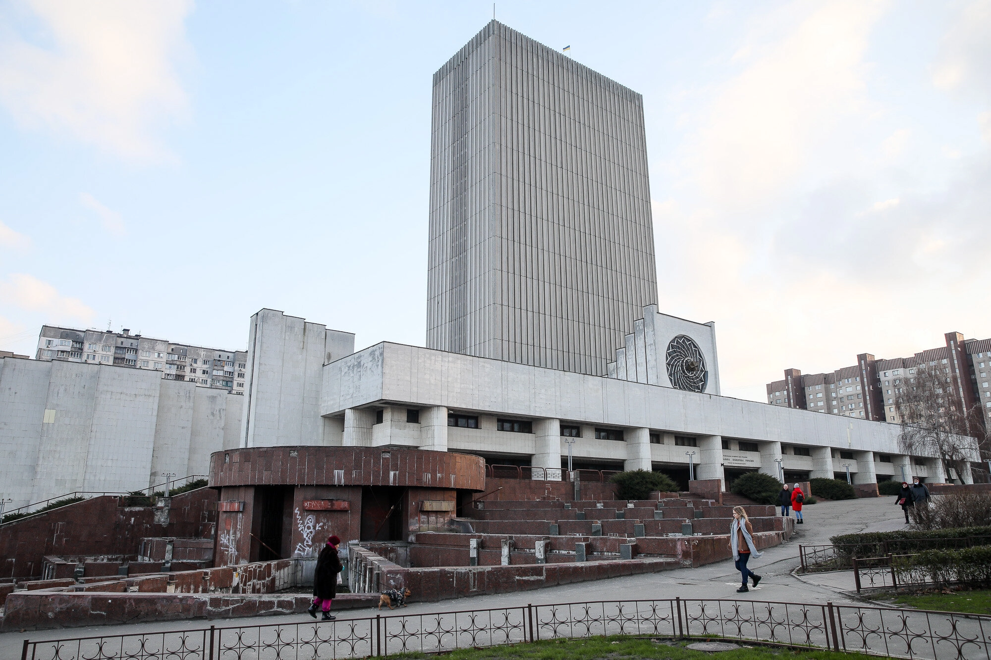 People pass the main building of the Vernadsky National Library, one of Kyiv’s most recognizable modernist structures, on Jan. 9, 2021.