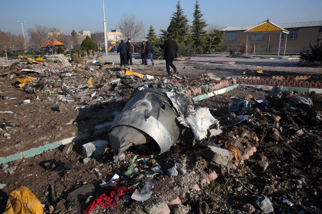 Rescue teams work amidst debris after a Ukrainian plane carrying 176 passengers crashed near Imam Khomeini airport in the Iranian capital Tehran early in the morning on Jan. 8, 2020, killing everyone on board.
