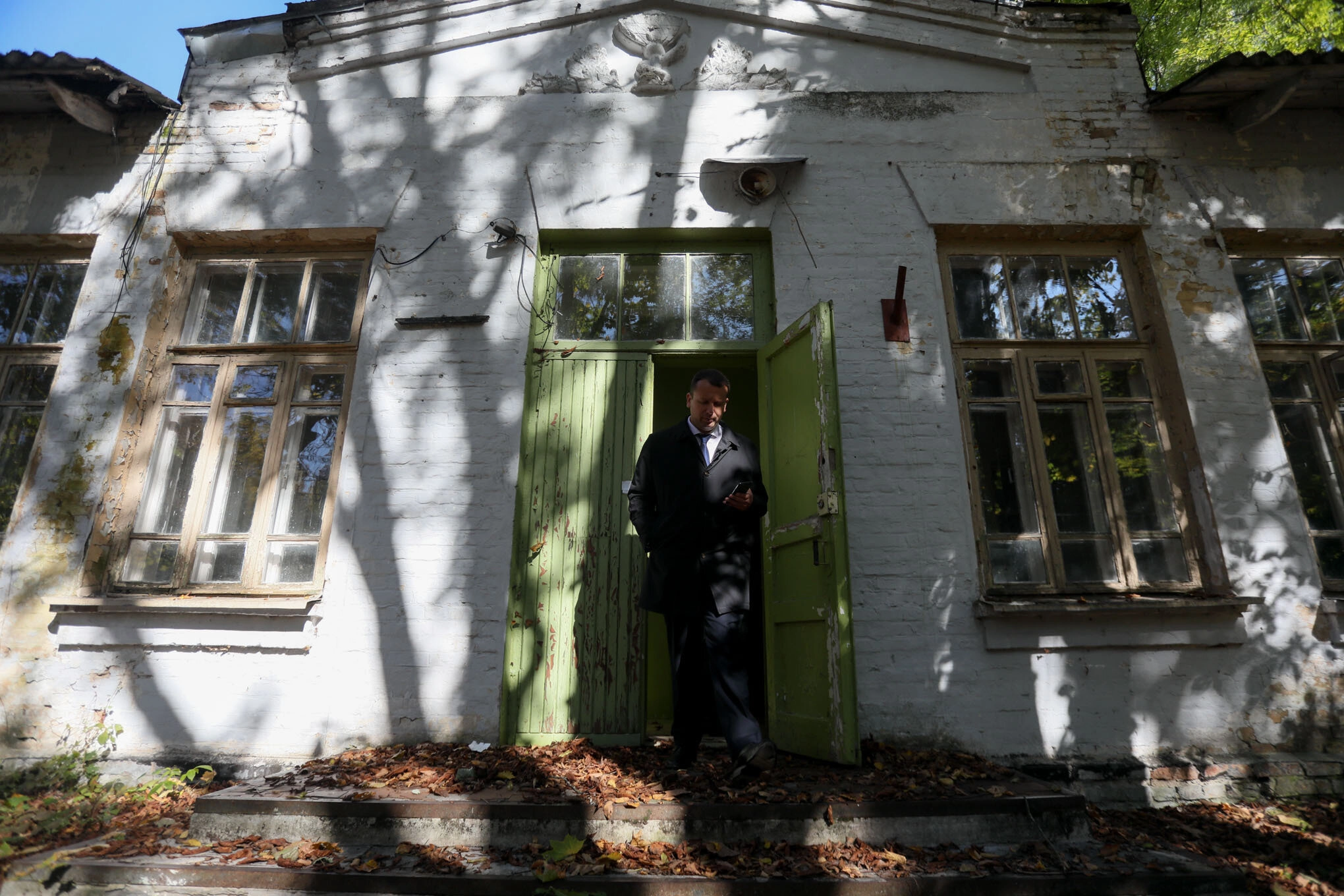 A man leaves a building in the city of Chornobyl on Oct. 5, 2021. The former dormitory for foresters will be rented out for a 5-year lease at the auction by the State Property Fund this year. (Oleg Petrasiuk)