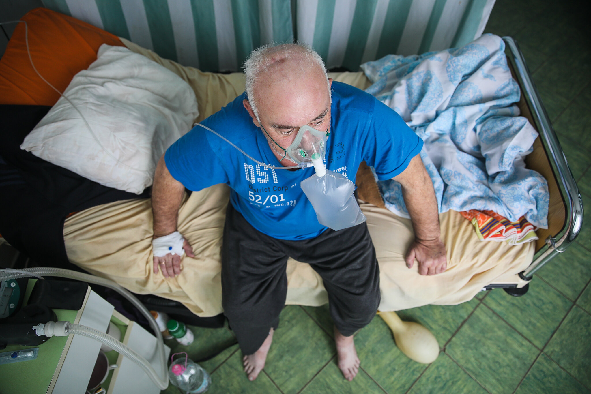 57-year-old Vasyl Stefurak sits on his hospital bed at Kolomyia District Hospital in Ivano-Frankivsk Oblast on March 16, 2021.