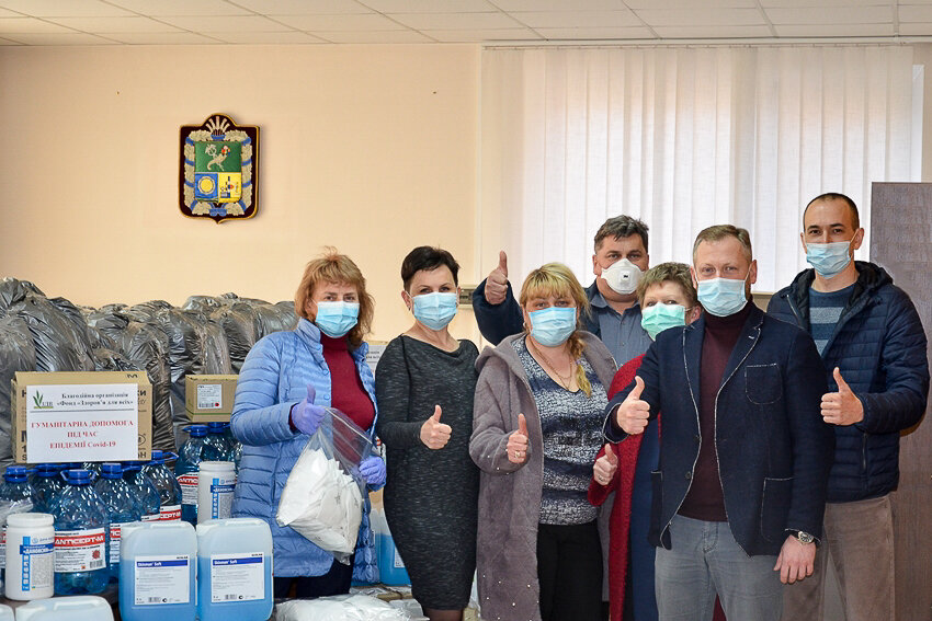Maksym Lytvynenko (R), chairman of the Kharkiv District Council, is featured handing the protective gear donated by Philip Morris to local doctors. 