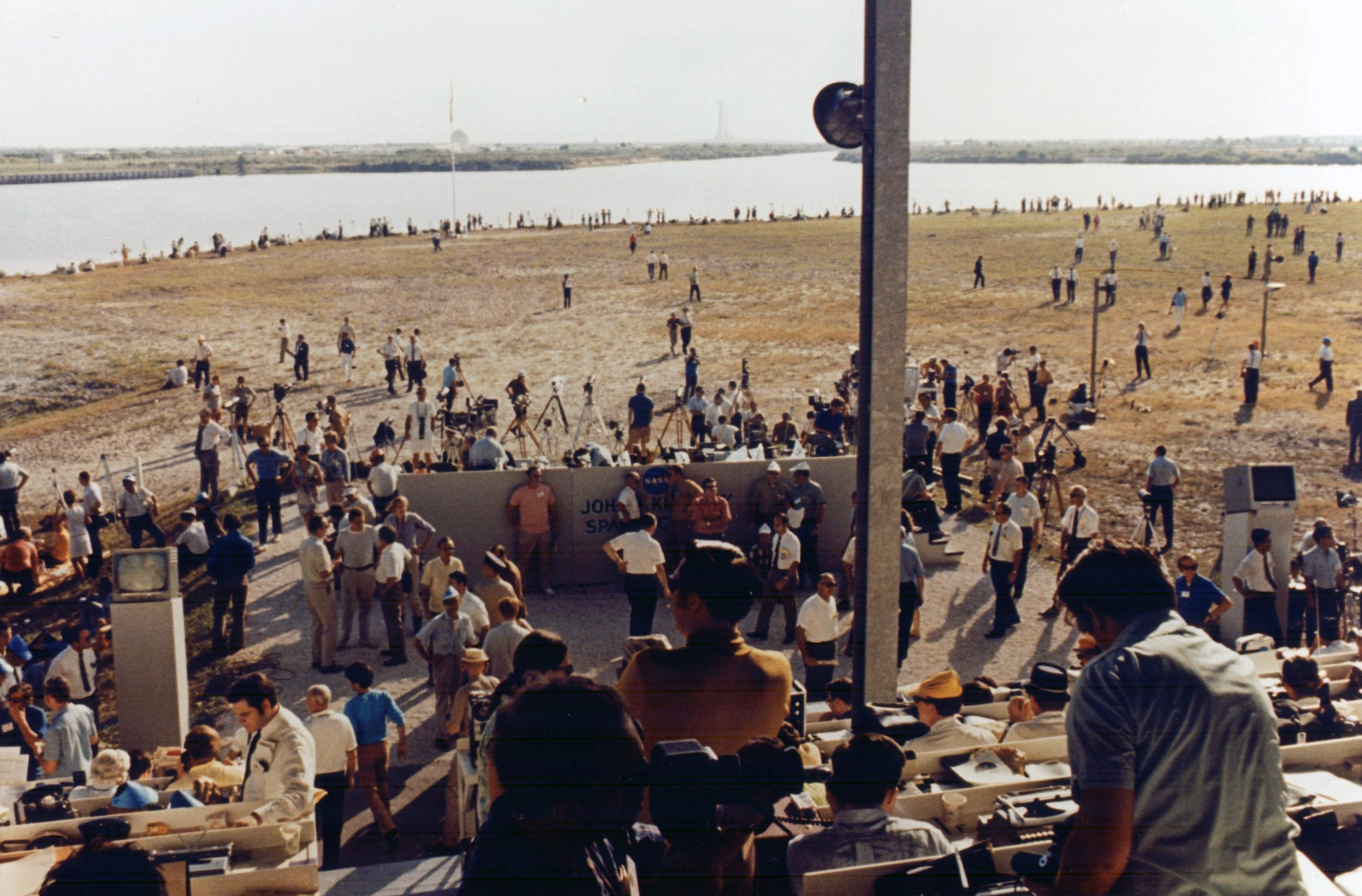 Journalists observe the historic Apollo 11 launch close to a launch pad of the Kennedy Space Center on July 16