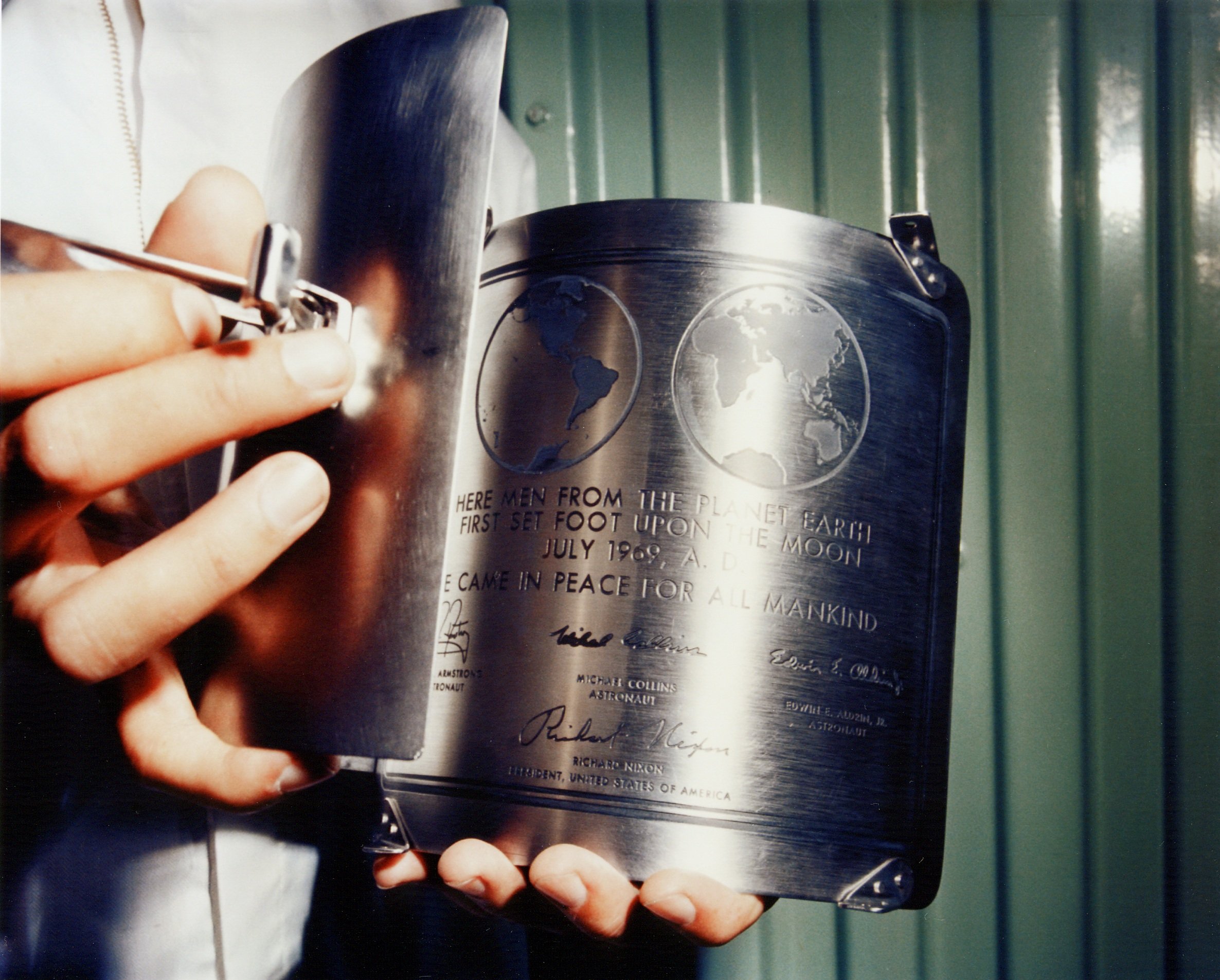 A NASA technician holds the Apollo 11 plaque prior to its installation on the lunar module ladder strut.
