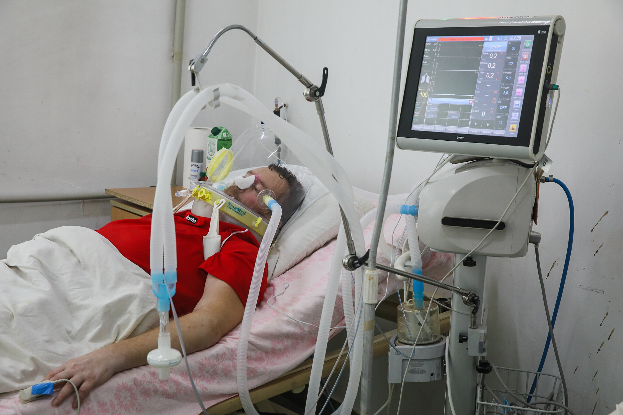 COVID-19 patient Vasyl wears a helmet supplying him with oxygen-enriched air at Kolomyia District Hospital in Ivano-Frankivsk Oblast on March 16, 2021.