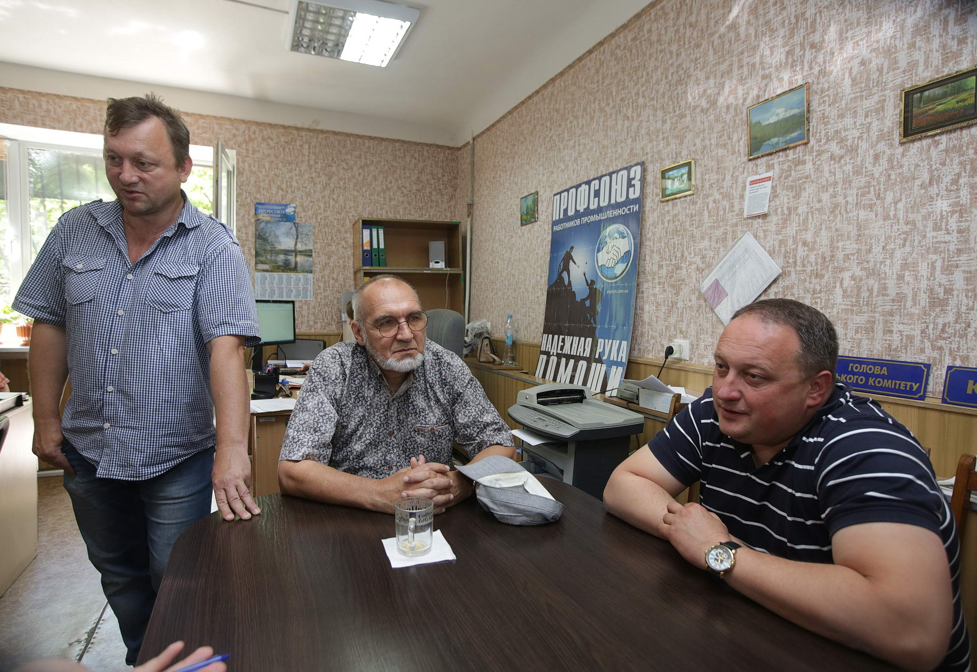 Organizers with the Kryvyi Rih Confederation of Free Trade Unions speak in their Kryvyi Rih office on June 7, amid a push for higher wages at the factory. 