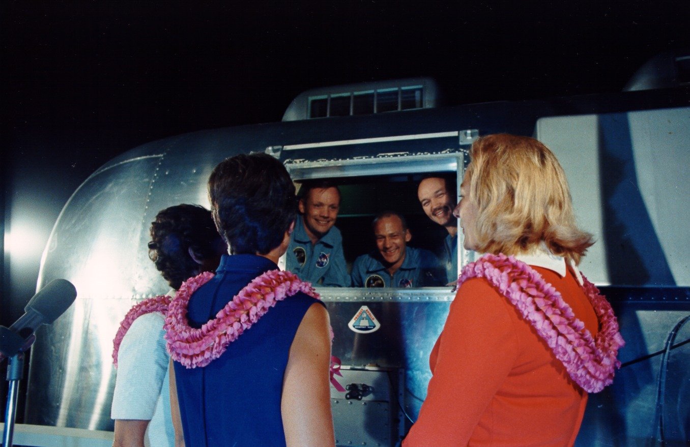 Apollo 11 astronauts greet their wives on arrival at Ellington Air Force Base, Texas, on 27 July 1969.